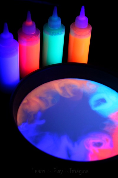 GLOWING magic milk experiment - cool science for kids with an added sensory element they will love.