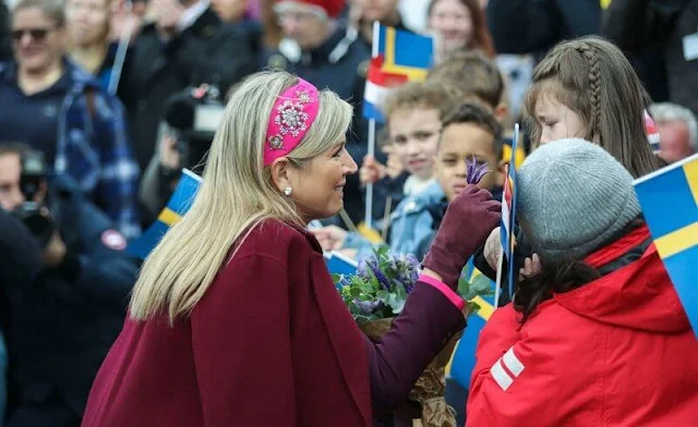 Queen Maxima wore a burgundy wool coat by Massimo Dutti