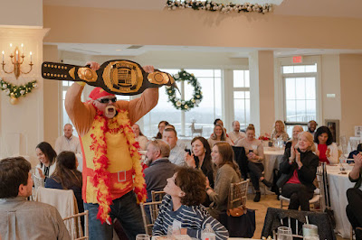 Man dressed in Hulk Hogan costume holding up JMC title belt