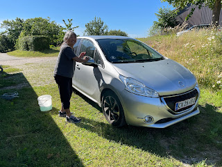 Carol washing Marie's car with rain barrel water