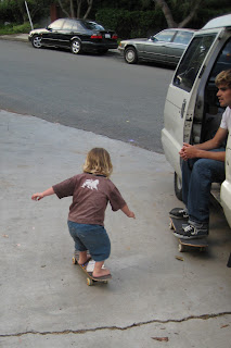 Emery skateboarding past Justin