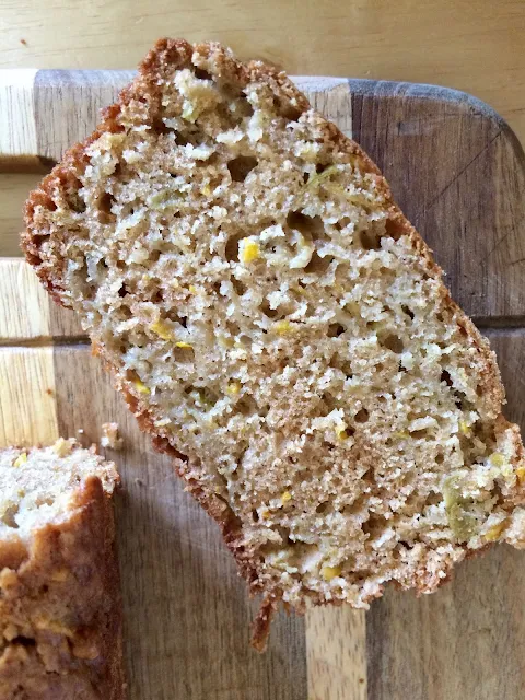 Slice of yellow squash and apple bread on a cutting board.