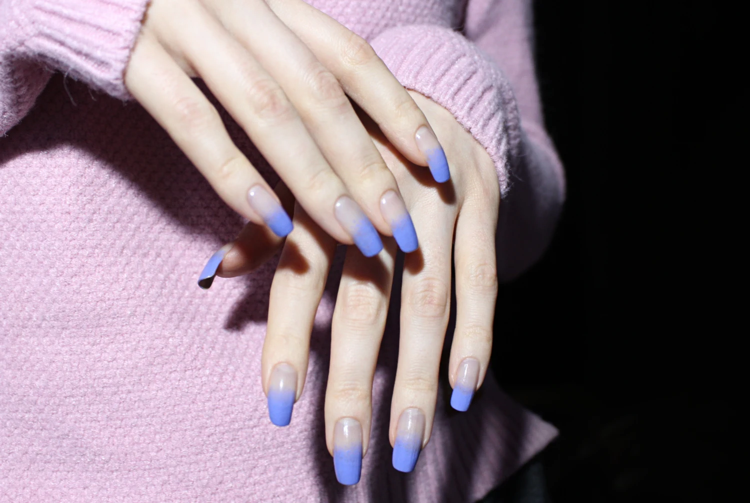 a close-up of long, natural nails with an ombre, lavender nail look