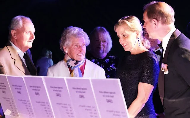 The Countess of Wessex wore a new bespoke floral print midi dress by Emilia Wickstead, and metallic fit-and-flare midi dress by Alaia