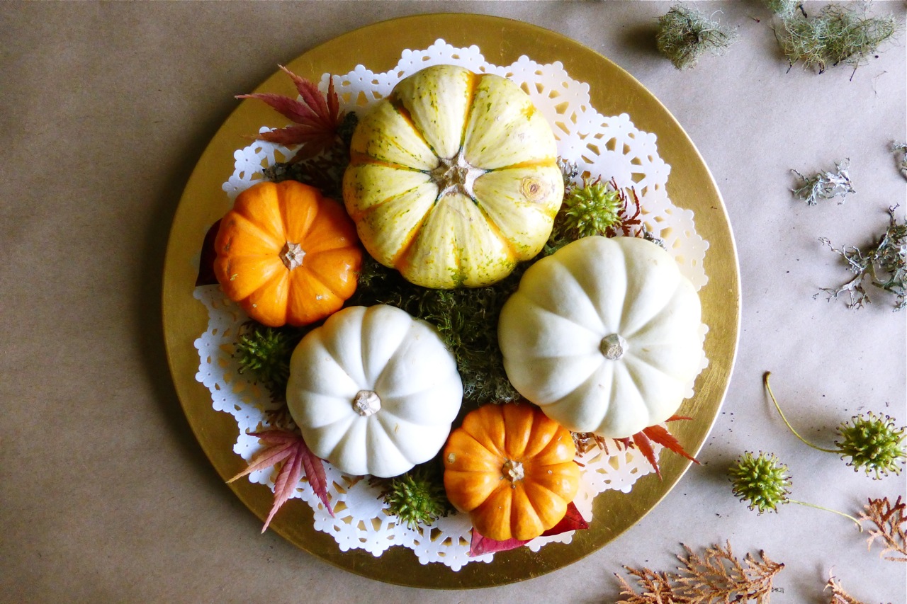 mini pumpkins, gold charger plate, doily, arborvitae springs, blueberry leaves, Japanese maple leaves, moss