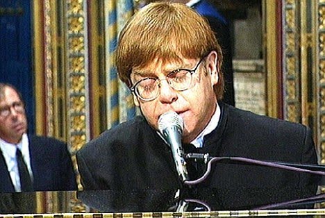 elton john royal wedding. Elton was pictured biting his