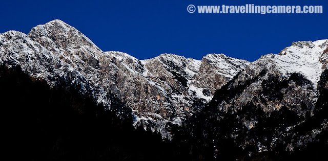 A wonderful place for adventurous campers: Sarahan, Kullu : Vandana Bhagra, Shimla : Hidden among the snow covered hills of Shrikhand Mountian Ranges, which are known for their mythological significance and is said to be one of the adobe of Lord Shiva, this unknown village beckon those with an adventurous spirit as its beautiful landscape and lush green valley will take your breath away. Many of you may get confused with Sarahan in Shimla district with its beautiful Bhimakali Temple but those you know and have been to Kullu will know this Sarahan better at 3200 metres height, and that too if they have had the zeal to walk all the way to picture its magnificent beauty.If you start your journey from Shimla then head towards Narkanda about 63 kms and then towards Nirmand which is another 28 kms approximately, with panoramic views of the Satluj Valley. From there you reach Bhagi Pul and then an uphill narrow road covering a distance of about 12 kms leads to this small village nestled among the mountains in all is pristine. Those who wish to travel by bus should be prepared for a long journey as it is nearly 176 kms from Shimla and can take up to 10 hours to reach, but of course with few stops and immense beauty to admire. Those planning to come from Beas side should be aware that there is no motorable road and would have to cross on foot from the Bishloi Pass.The HPPWD rest house situated outside the village offers decent accommodation which needs to be booked in advance but for the more adventurous laying out their tents (which of course you need to carry) in the open meadows can always be an option. With permission from the Government School nearby you can set your camp under the starry sky. The huge ground in the centre of the village is surrounded by fields, flora and fauna, water streams, waterfalls with amazing views of the snow covered hills nearby.  With so much natural beauty around it becomes quite hard to concentrate on anything and then there were these kids studying in their open air classrooms.Those rring to go can begin their trek from Kullu Sarahan to Bashleo Pass through the dense forests and green meadows to experience this place and its serenity. A one day trek to the nearest snow covered peak is an enjoyable experience as one would come across innumerable waterfalls, small stream and unexplainable natural beauty. The freshness and the virginity of the place suddenly hits you taking you thousands and thousands of miles away from your hustle bustle city life.  Other trekking options include heading towards the Jaon village to begin the Shrikhand trek through various hills, forests and streams. Village folk are often seen walking all the distance to Bangar and making it back by dinner time.The most typical feature about this village is its beautiful temple dedicated to sage Shring and gives a feeling of being a step closer to god and reaching for the sky. The use of vibrant colours, intricate artwork and unique architectural style will capture your imagination. The snow covered hills behind the templegives it a perfect backdrop of picture perfect beauty. The recently concluded two day Jhiru mela held during sangrand in April celebrates the beginning of the New Year which witnesses the village folk in their traditional dresses, dancing and singing to folk songs and wishing for prosperity.In case you plan a trip to Kullu and its better known destination do not forget to enquire about this small little village as it will equally charm you as would the other destinations.Photo credits: VJ Sharma