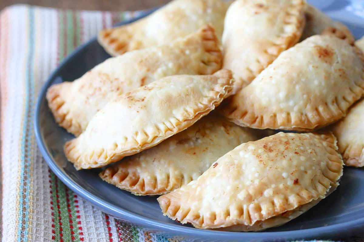 Mini Chicken Empanadas with Cheese and Chiles on a blue plate.