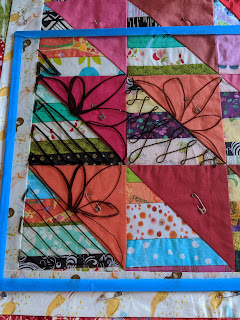 A plastic overlay is used to mark free motion petals, libbon candy, and parallel lines that might be used on The Square Deal quilt.