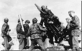 Waffen SS soldiers fire the formidable German 88mm gun. It acted both as a tank-buster and as anti-aircraft gun.