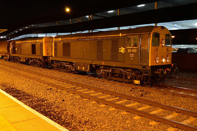 Night photo of Class 20107 and 20096 diesel locomotives in British Rail livery heading a London Underground rolling stock train at Banbury 2017