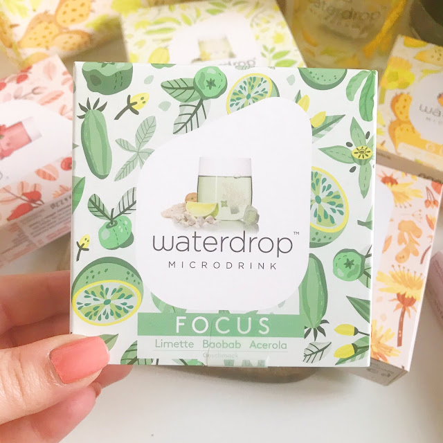 closeup of focus waterdrop microdrink with other flavours laid out in background