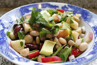 salad of beans and avocads in a blue and white bowl