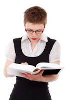 A woman reading a course guide book
