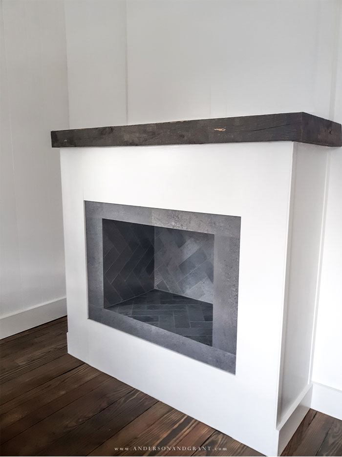 White fireplace with gray tile insert