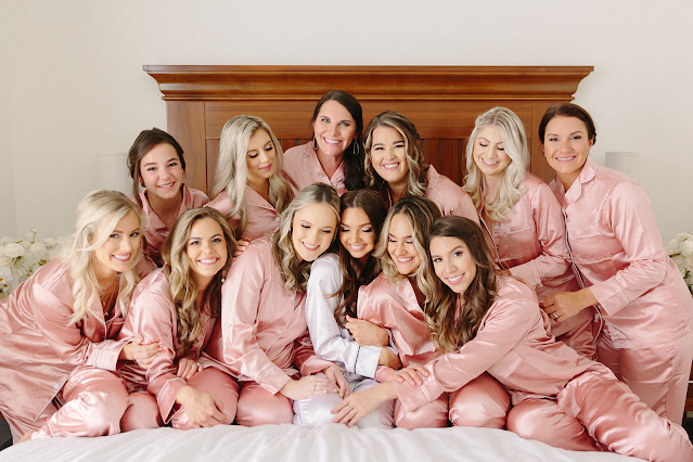 bride with bridesmaids in pink robes