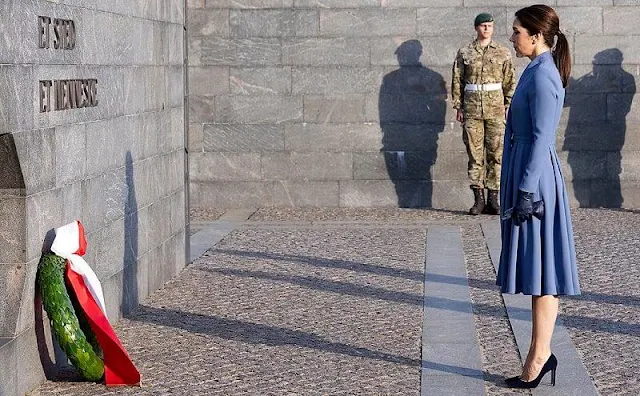 Crown Princess Mary wore a blue coat dress. The Royal family lit their candles at 8pm, the exact time that the Germans surrendered