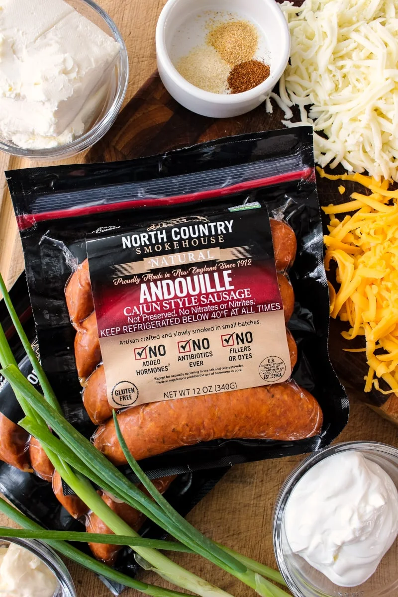 Cheesy Baked Andouille Dip is not your average sausage dip. It is creamy, super cheesy, easy to make, and full of bold Cajun flavor that will knock your socks off!  #northcountrysmokehouse #certifiedhumane #organic #superbowl #ad