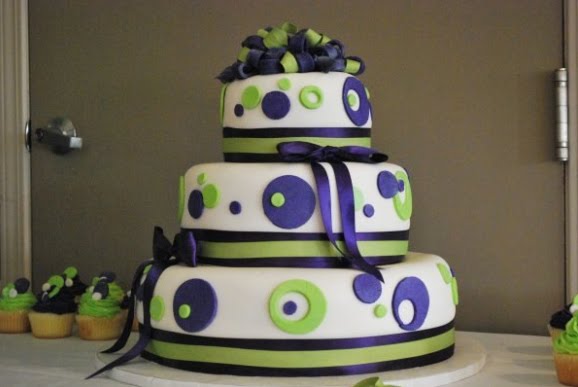 Modern three tier wedding cake with purple and green decorative circles
