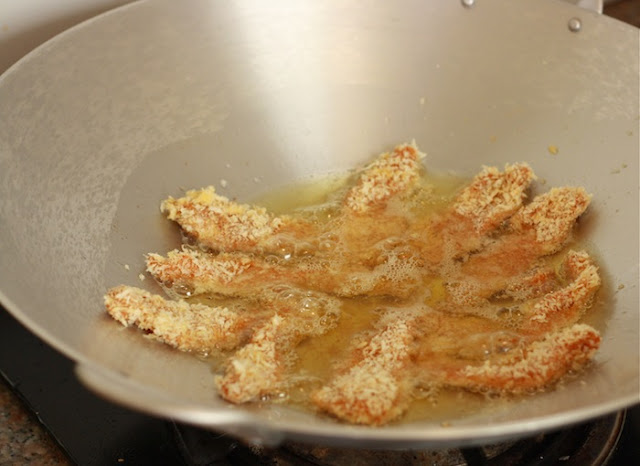 frying chicken tenders in a wok for katsu