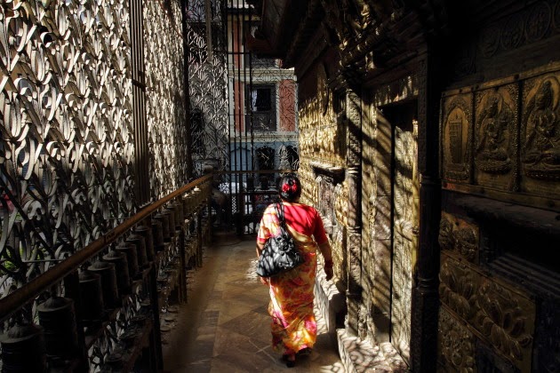 Nepali lady offering her prayers at a Hindu Buddhist temple in Kathmandu