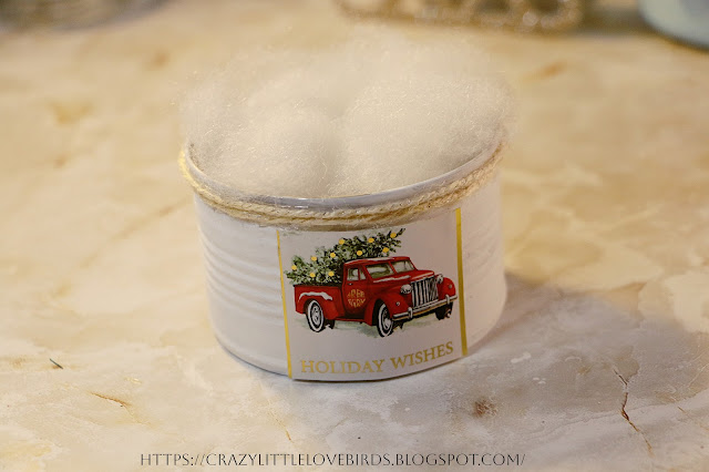 Painted metal can with cotton snow inside