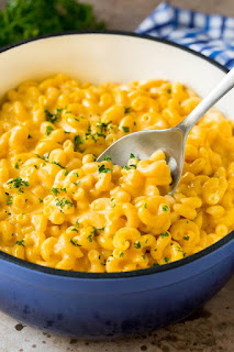 macaroni cook with cheese in bowl with spoon