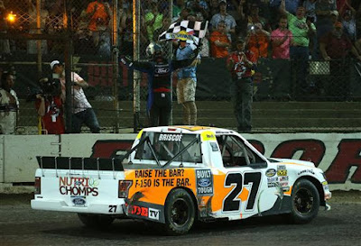 Chase Briscoe, driver of the #27 Ford Ford, celebrates with the checkered flag after winning the NASCAR Camping World Truck Series Eldora Dirt Derby at Eldora Speedway on July 18, 2018 in Rossburg, Ohio.