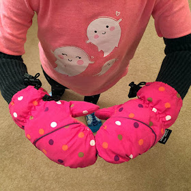 Child wearing home made long snow mittens