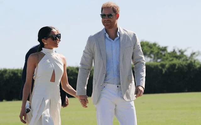 Meghan Markle, Duchess of Sussex wore an ivory silk ginger dress by Heidi Merrick at the Royal Salute Polo Challenge
