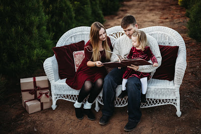 Family on bench reading book for Christmas Holiday Mini Session in San Diego