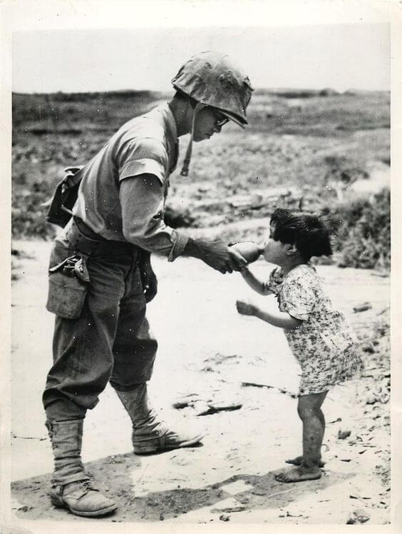 12 Powerful Images That Prove There's Still Kindness In The World - This US marine is offering water to a Japanese girl he discovered in a cave. (1945, Okinawa)