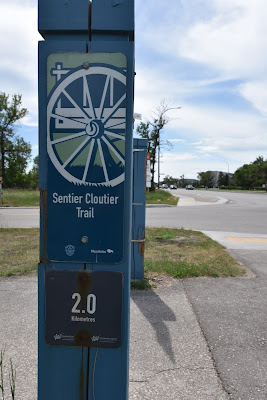 Sentier Cloutier Trail sign and marker post.