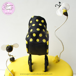 Side view and details on gumpaste baby shower stroller cake topper