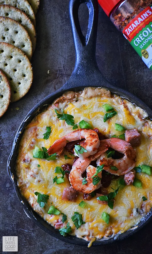 Over head shot of the Skillet Jambalaya dip garnished with whole shrimp and cilantro. Crackers on the side