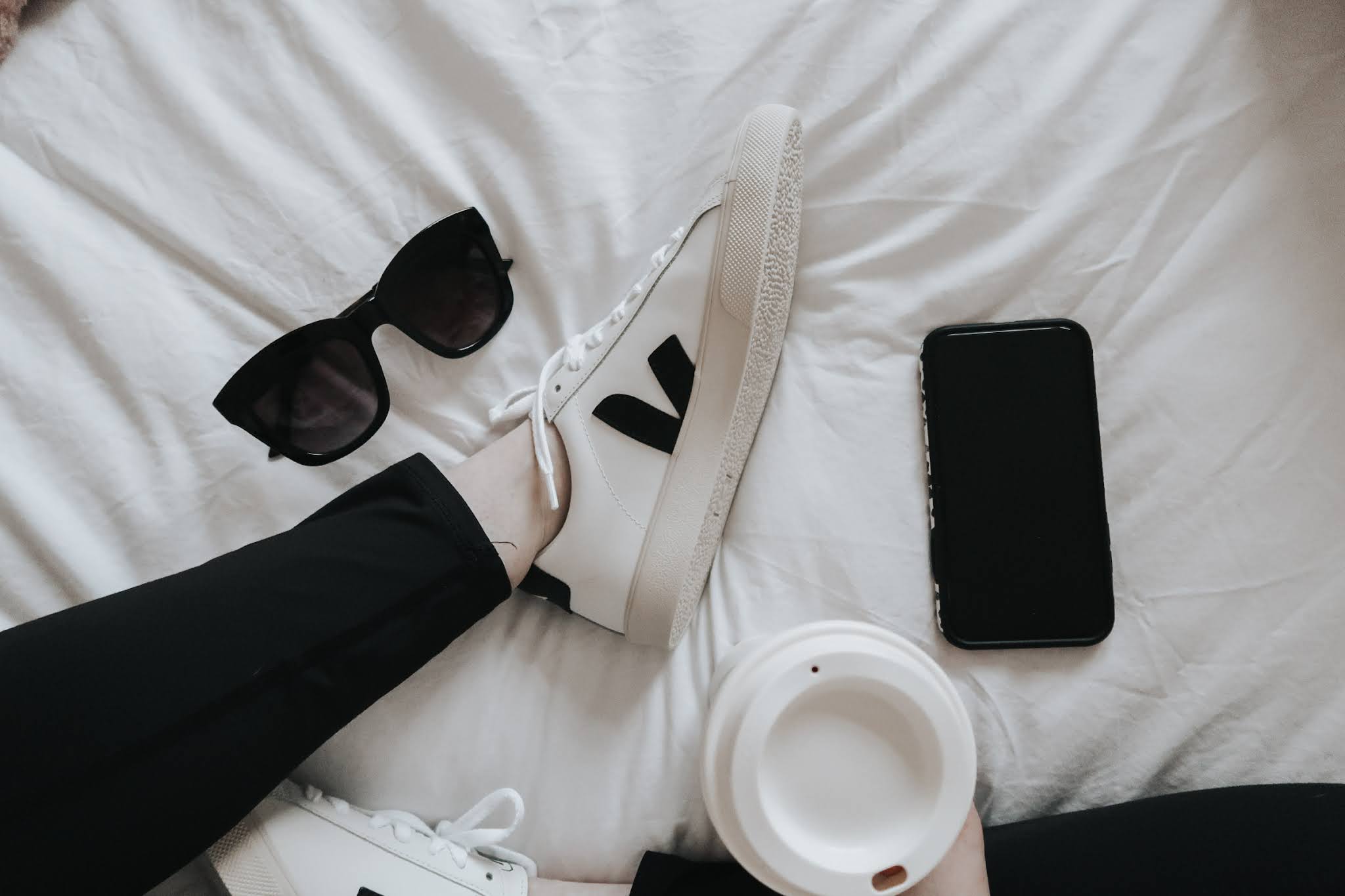 Veja trainers on a bed.