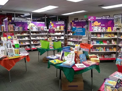 Scholastic Book Fair cabinets and tables, displaying books, in SRCSA library