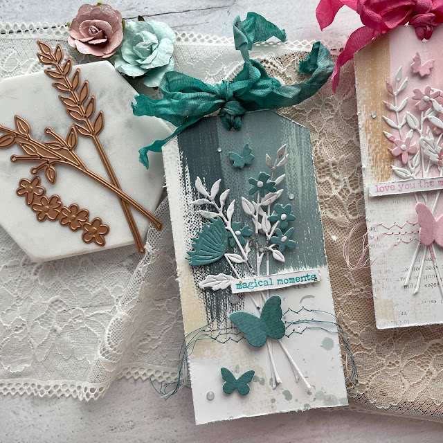 Monochromatic Floral Tag Trio created with: Spellbinders floral reflection sealed wildflowers die, color my world butterfly burst die, opal gems; 49 and Market spectrum sherbet paper; Tim Holtz crinkle ribbon, distress oxide ink, distress spray stain, distress mica spray; Scrapbook.com best day ever wordfetti stamp, foam adhesive