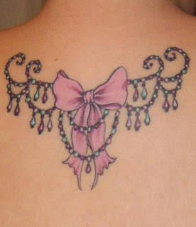 Decorative pink bow tattoo