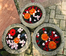 floating flowers in three stone pots