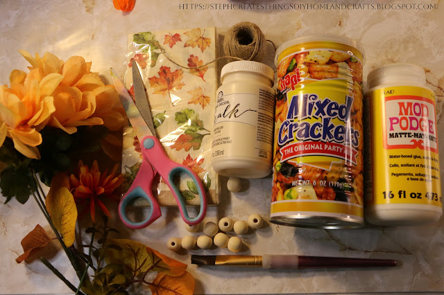 Craft materials, acrylic paint, metal can, scissors, wooden beads, faux floral, twine
