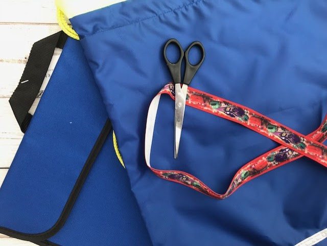 Book bag and drawstring bag laid out with scissors and ribbon