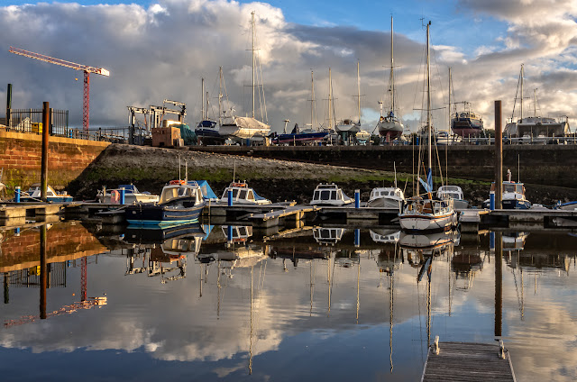 Photo of some of the small fishing boats at Maryport Marina with the hard standing in the background