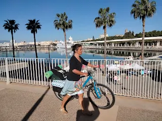 Aim'jie pushing her bicycle