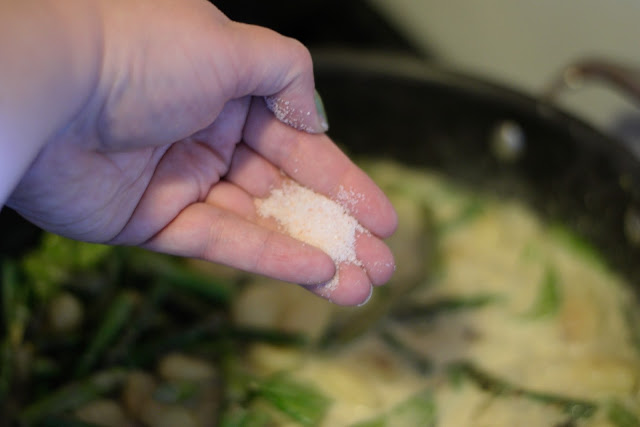 Salt being added to the pan. 