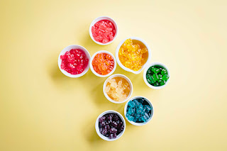 Gummy bears sorted in cups by colours