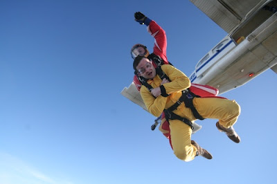 photo shows another guy, dressed in yellow, strapped to the front of someone else, panicking like i'll probably be. You can see the plane they've jumped out of in the background