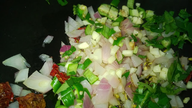 Adding green chili curry leaves and garlic