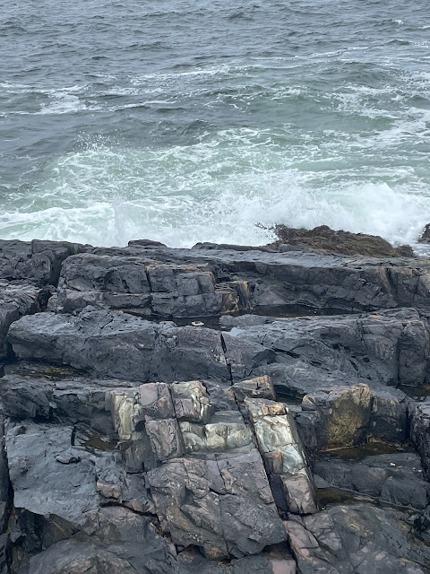 A different view of the rocks as the waves crash upon them.