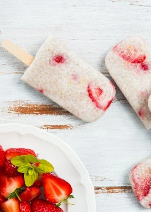 How to make strawberry chia seed popsicles recipe. This clean eating ice pops are made with strawberries and coconut milk or almond milk. They are low calorie with honey or maple syrup.  Make these healthy popsicle for kids this summer.  Simple homemade sugar free berry chia seed pops. Healthy recipes with fruit.  Diy vegan and easy chia seed recipe. #strawberry #chiaseed